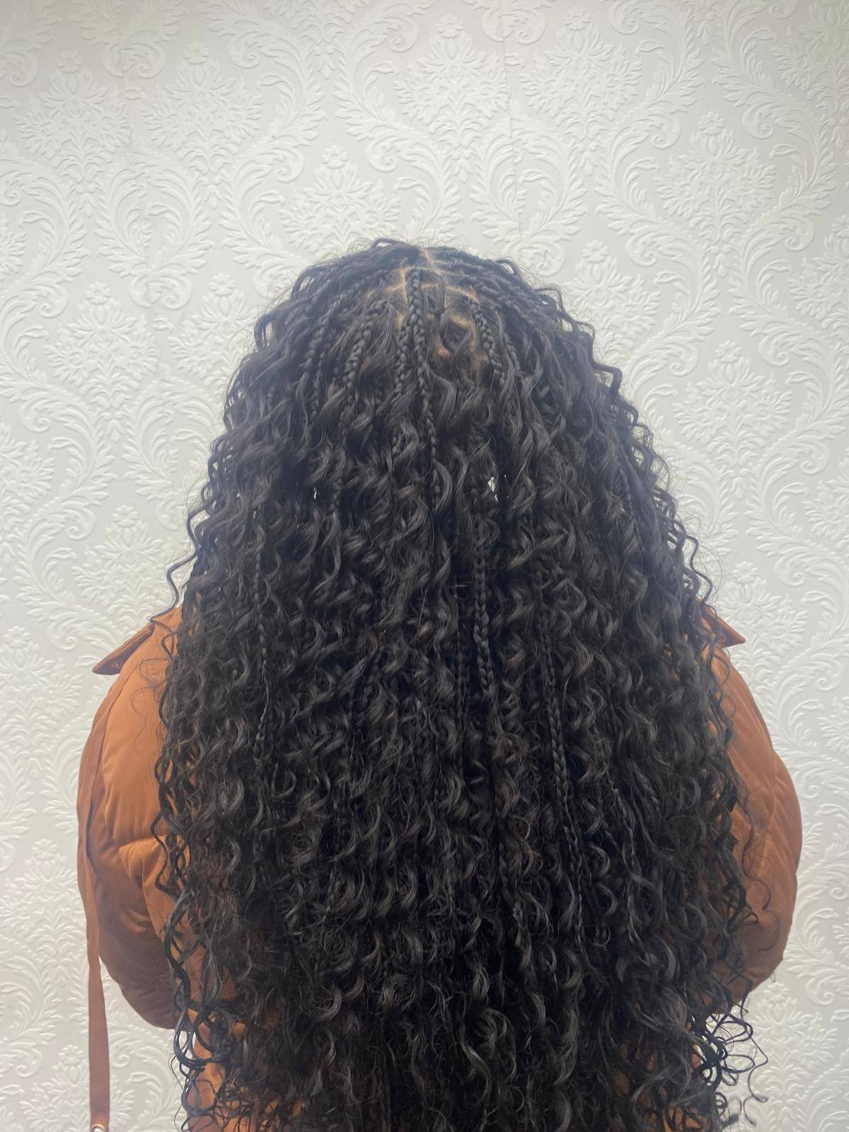 Boho braids with curl accents viewed from behind