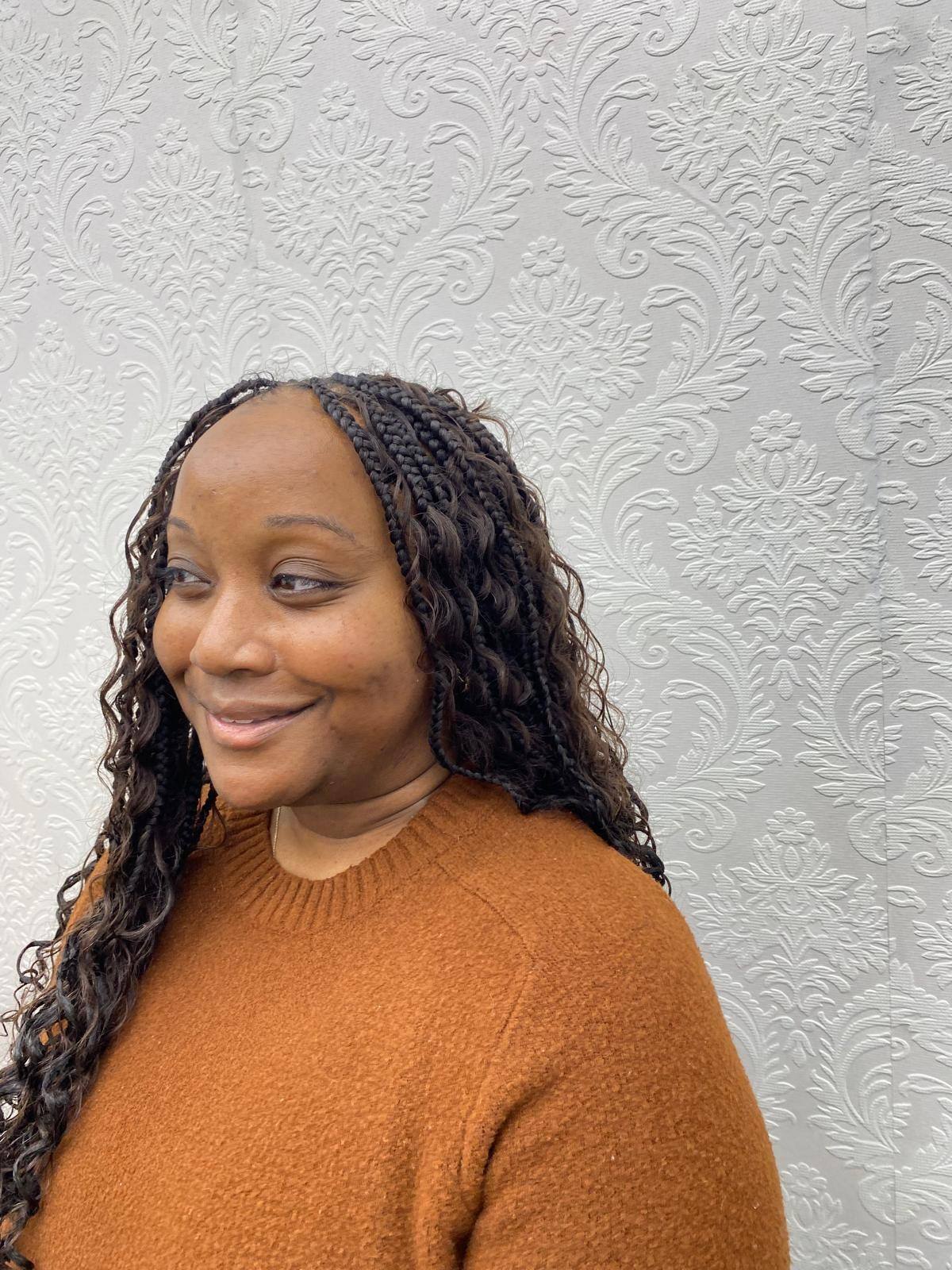 Client smiling with freshly installed boho braids