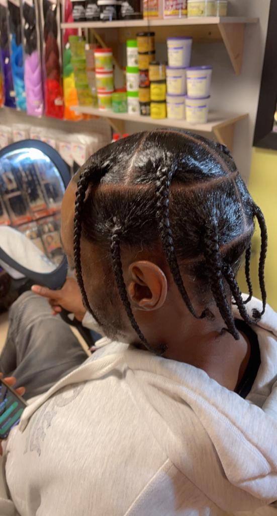 Cornrows being braided in the Annandale salon