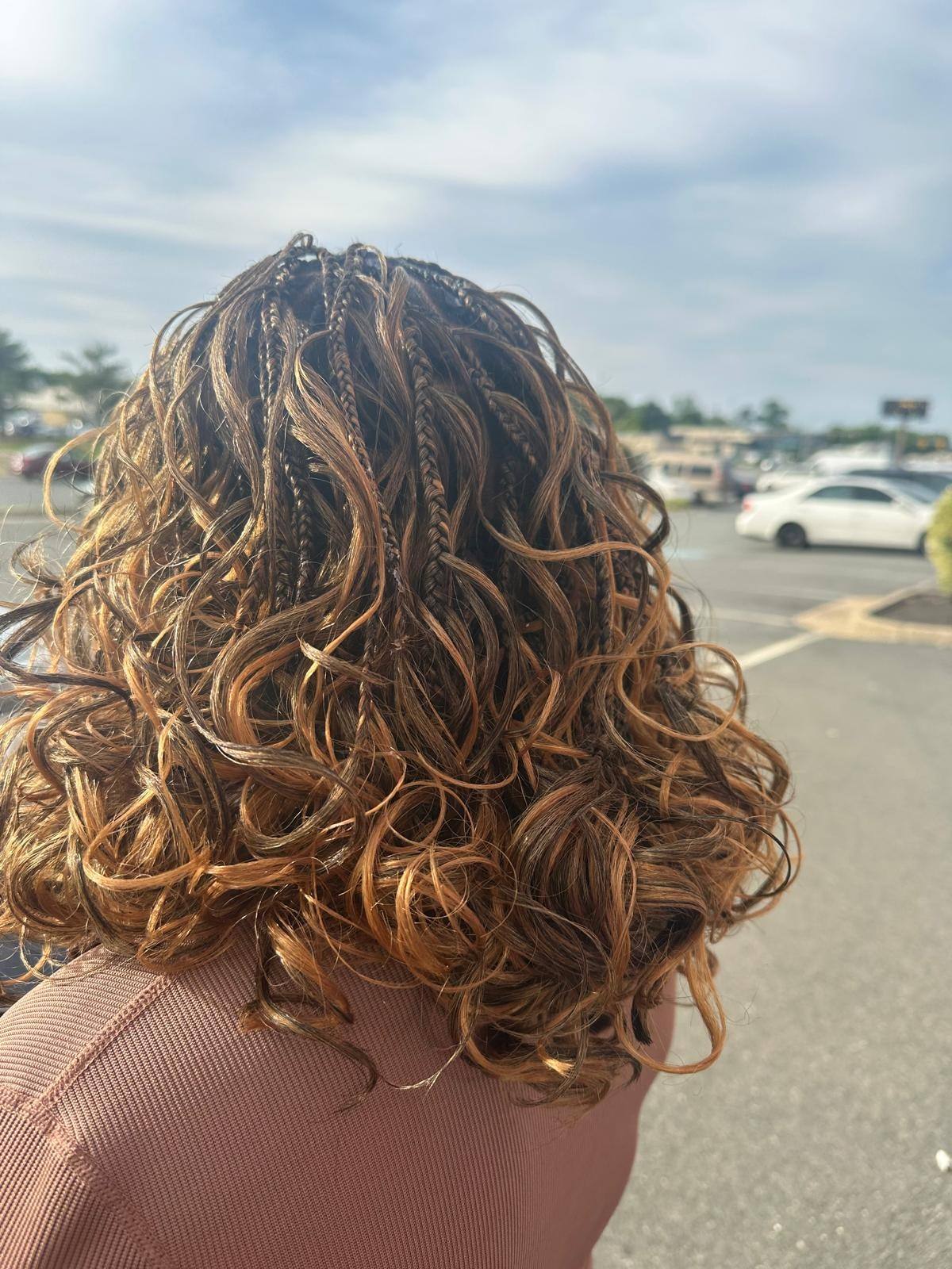 Honey crochet curls styled short, photographed outdoors