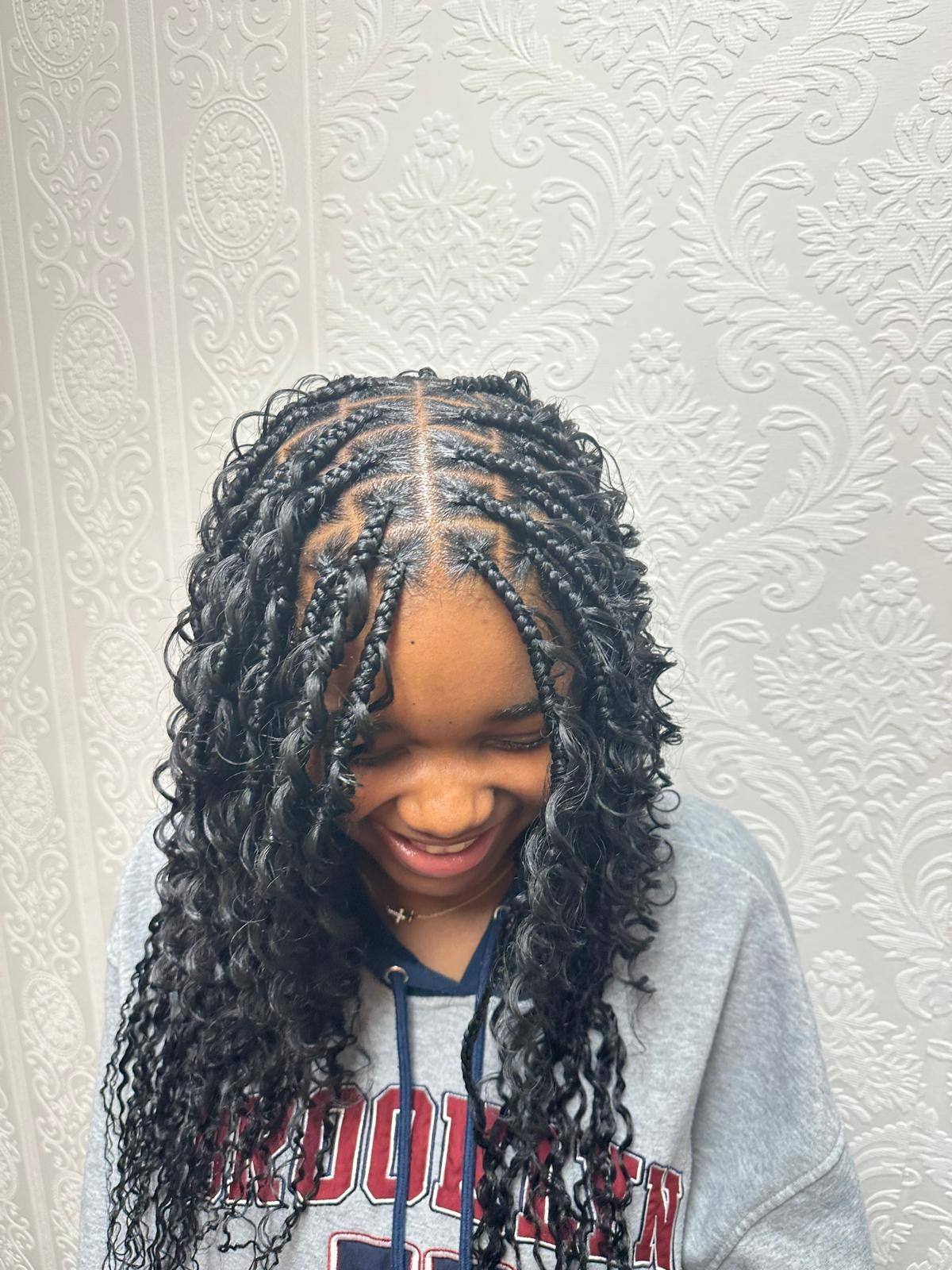 Young client's boho braids, side view