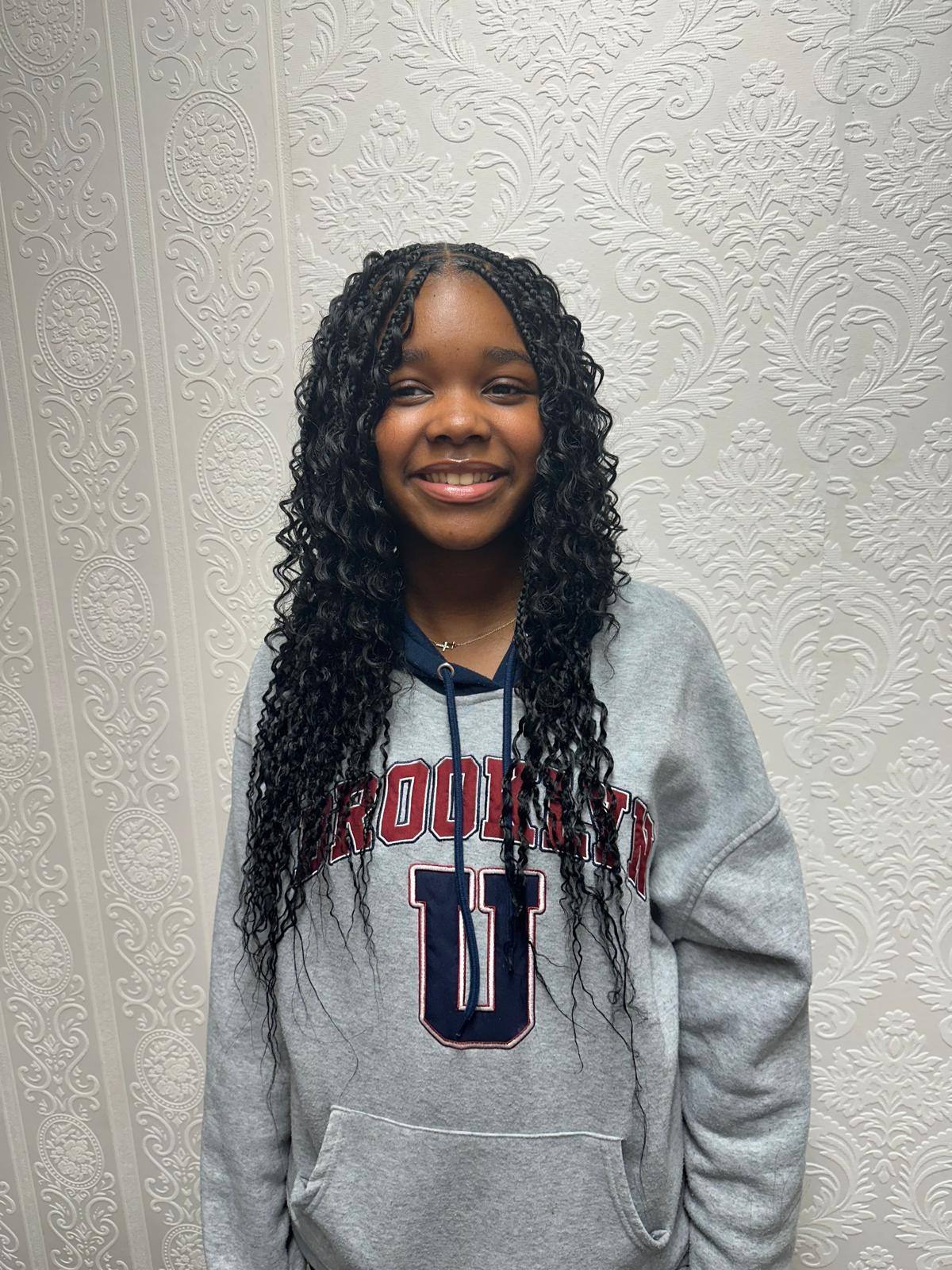 Young client smiling with boho braids