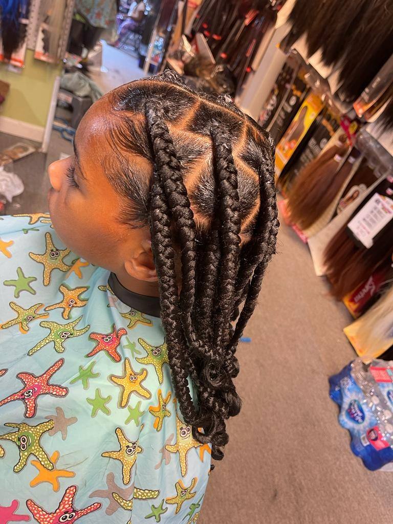 Child's medium knotless braids finished with soft curly ends