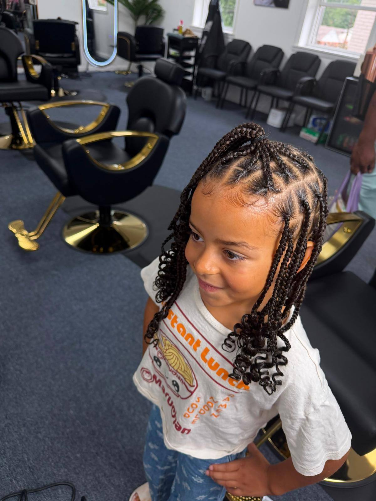 Young client with beaded braids in the salon