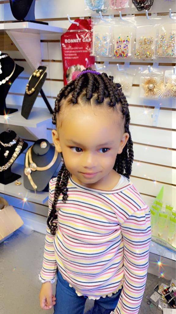 Toddler with fresh cornrows standing in the salon