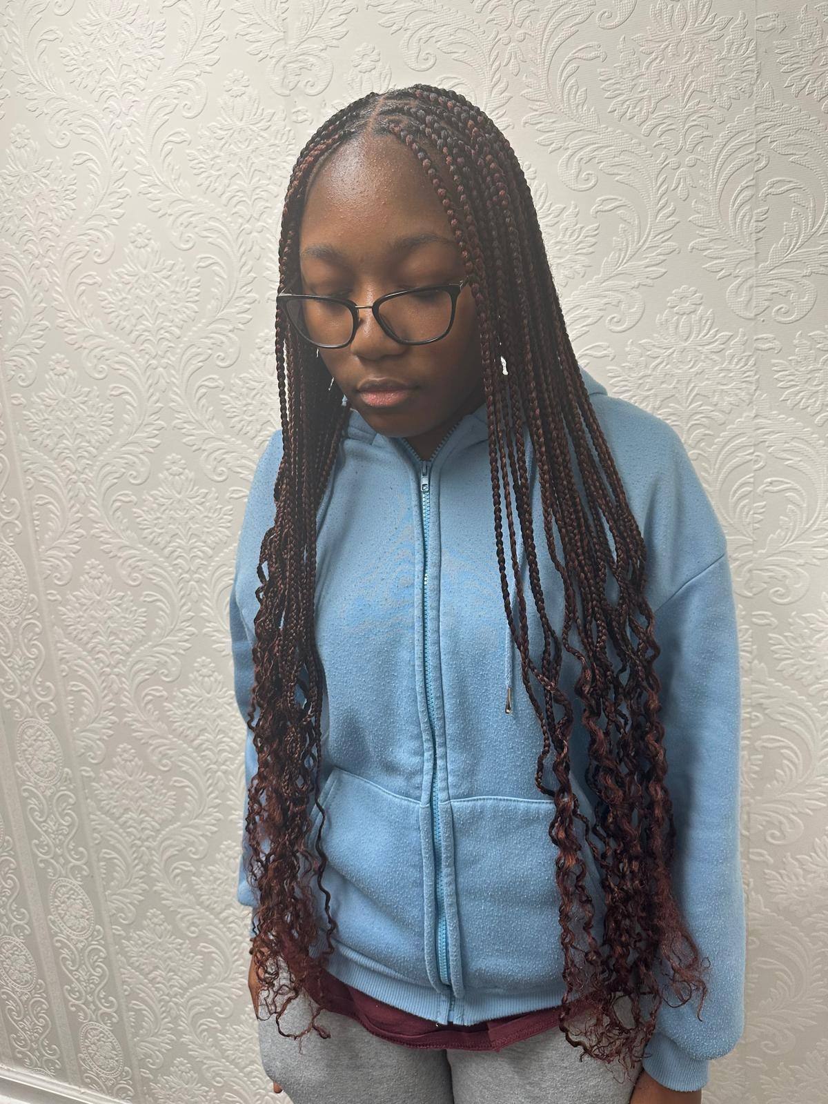 Young client with knotless braids and curly ends