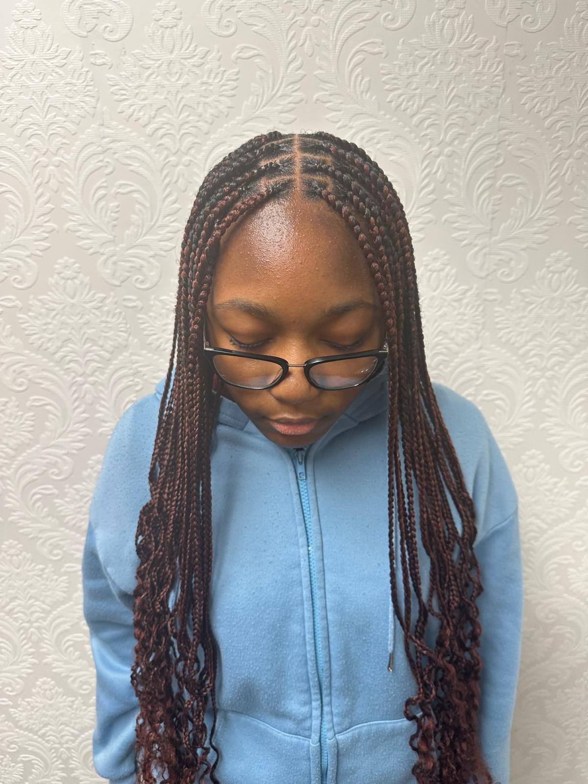 Young client's knotless braids, front portrait