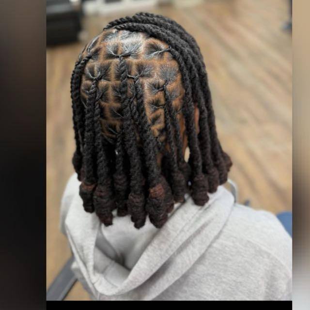 Short two-strand twists at bob length on square partings, coiled ends, back view