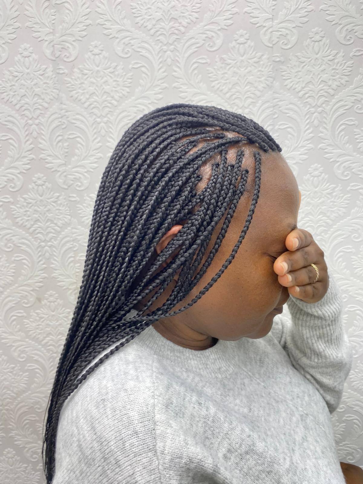 Knotless braids showing clean box partings, side view