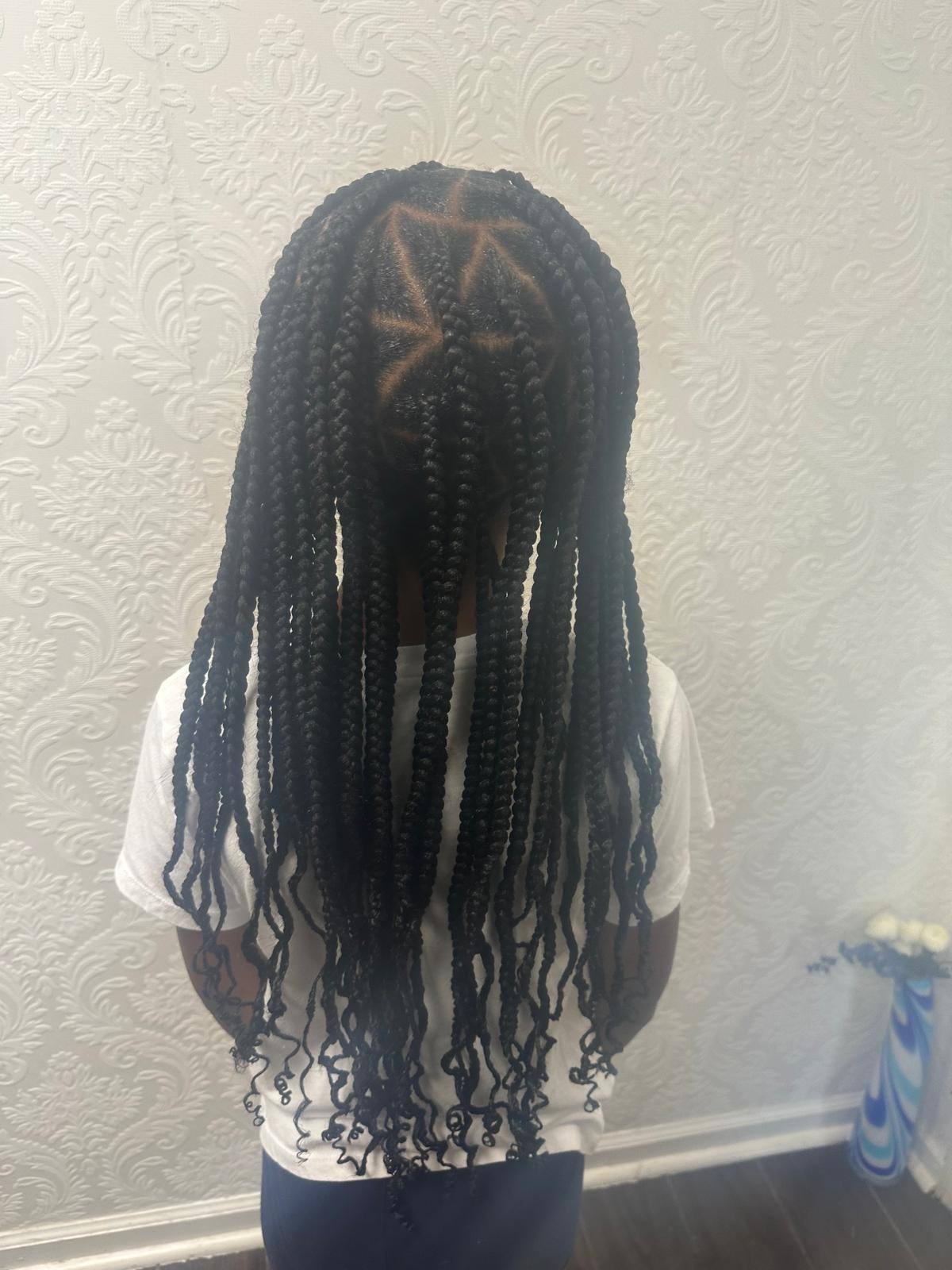 Knotless braids with curly ends, straight back view