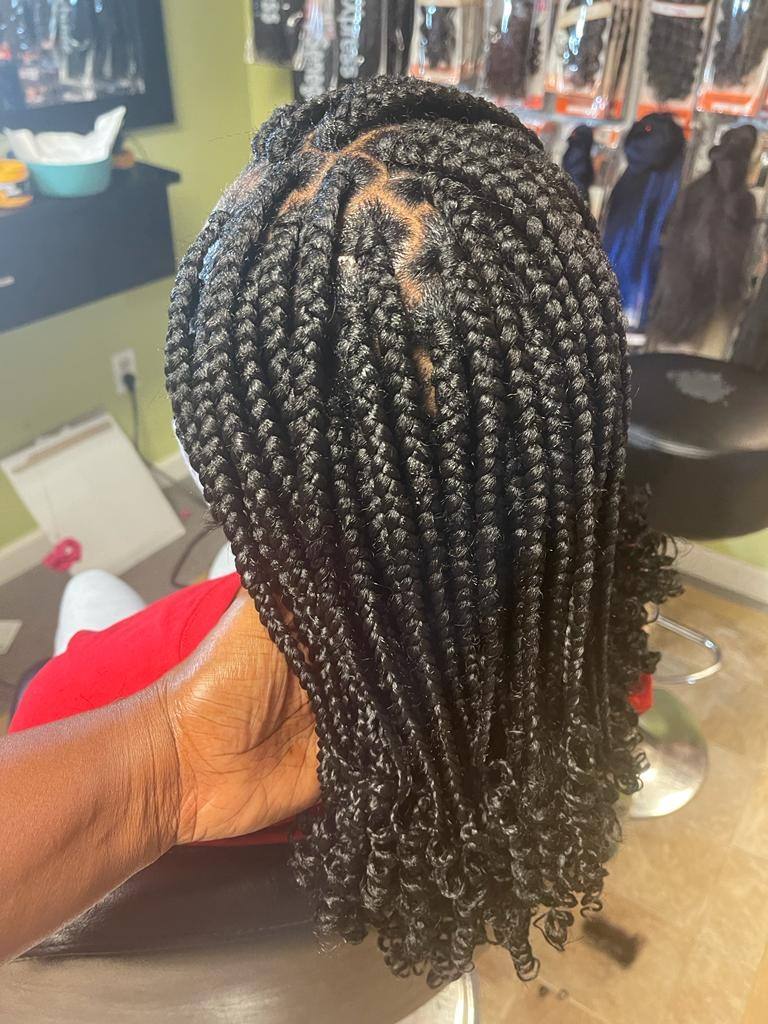 Medium knotless braids with loose curly ends, back view