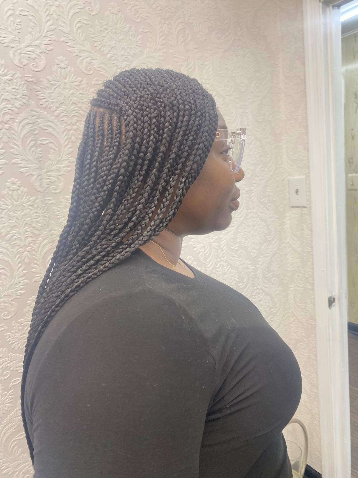 Knotless braids styled long, side view