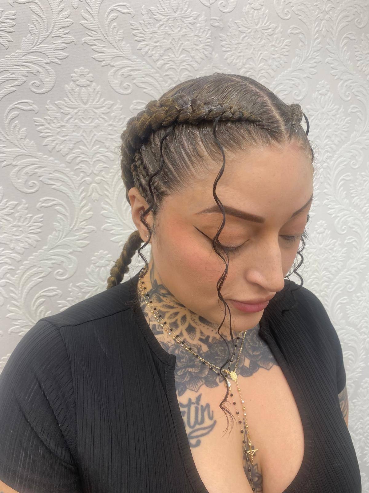 Knotless braids styled with a swooped front parting