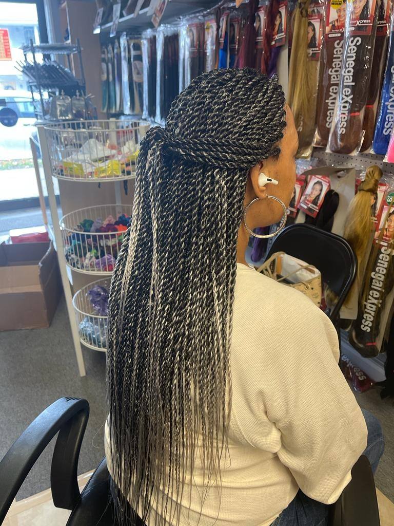 Long Senegalese twists styled half up, back view