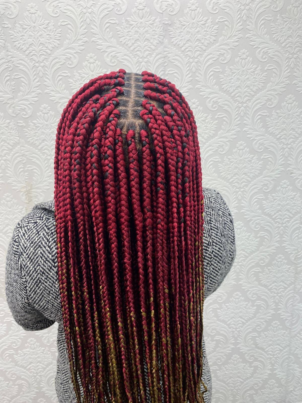Long burgundy twists styled straight down the back